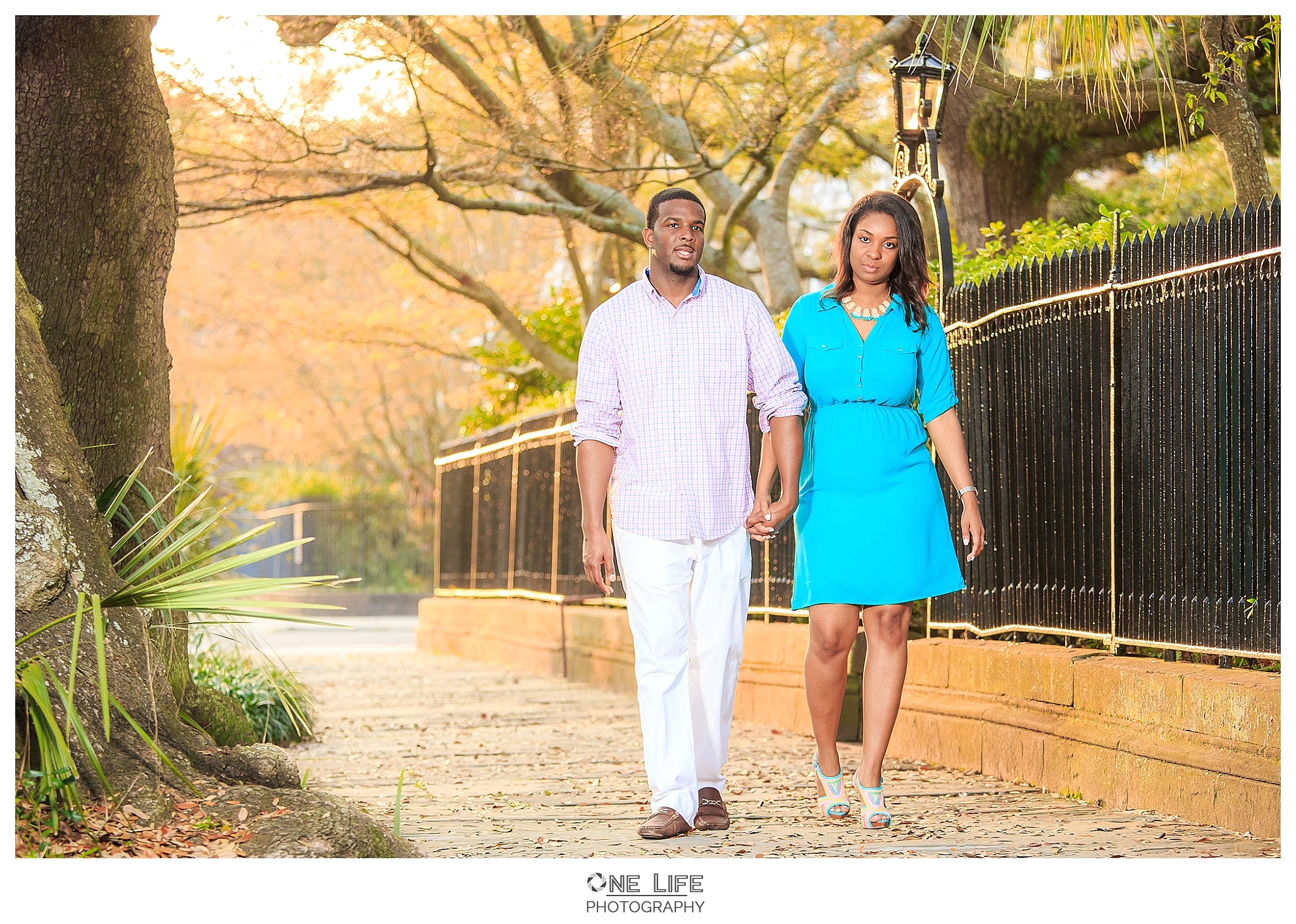 Couple walking on the old streets of Charleston during their engagement session