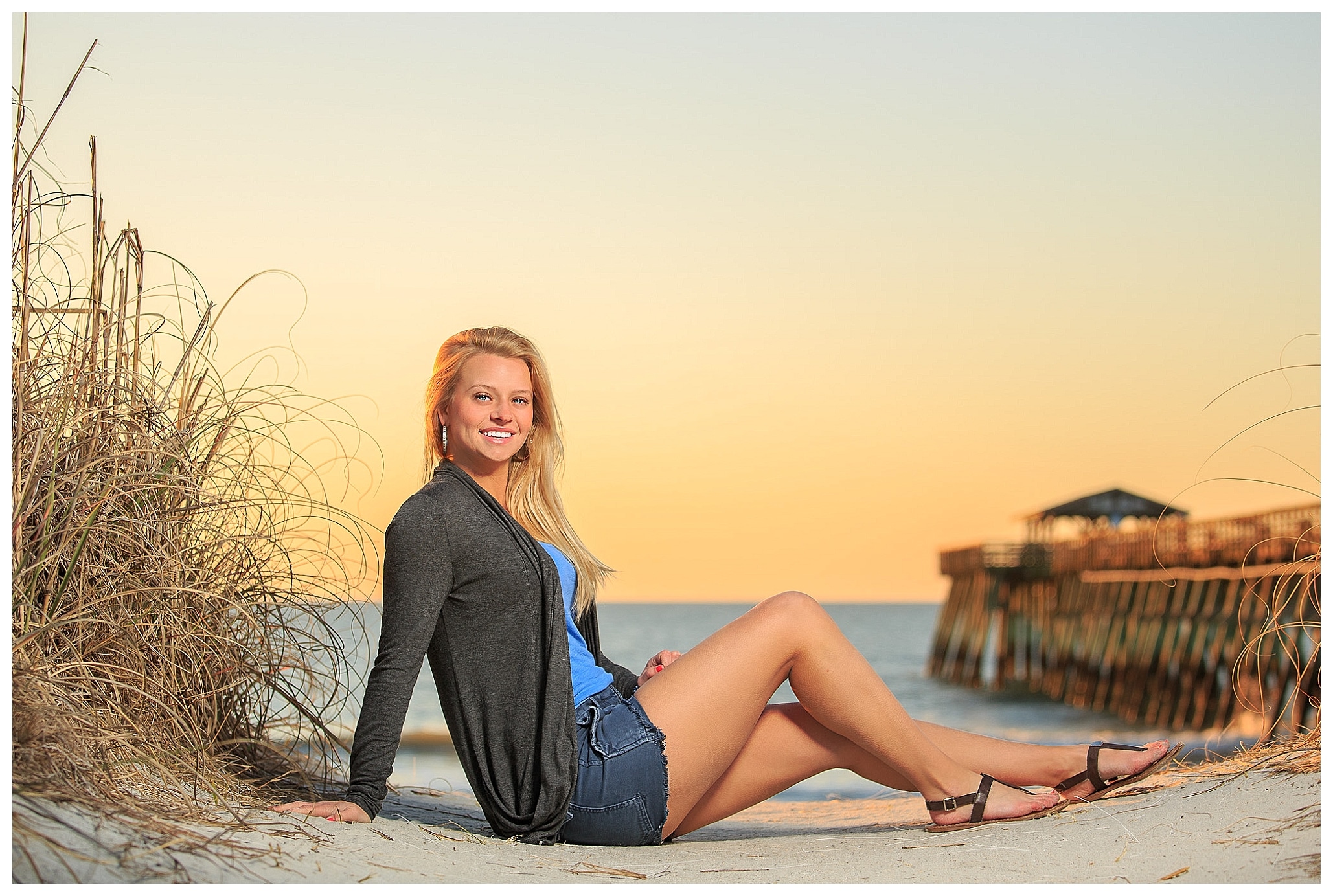 Girl sitting on the beach on her first professional photo session.