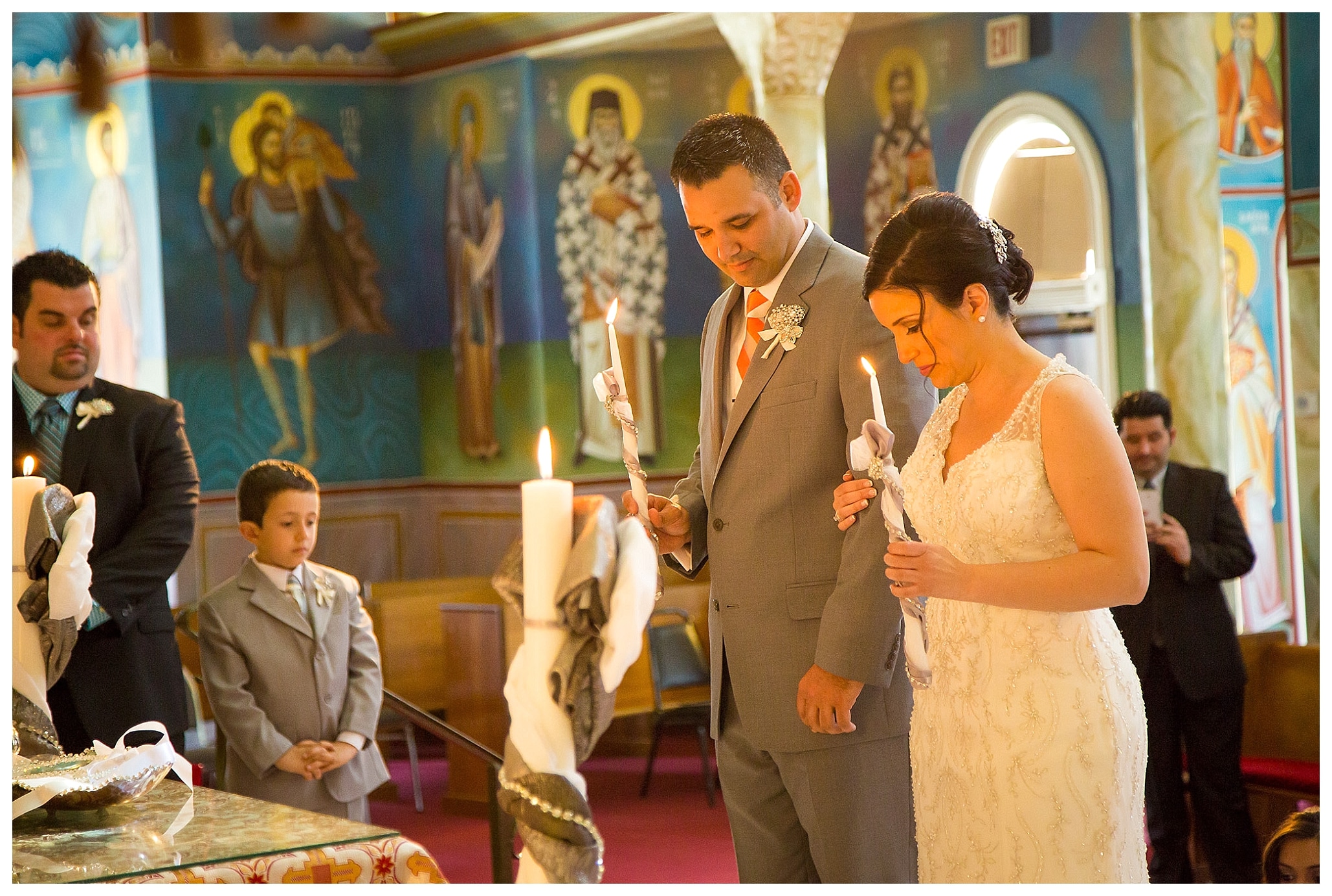 Couple holding candles during the ceremony