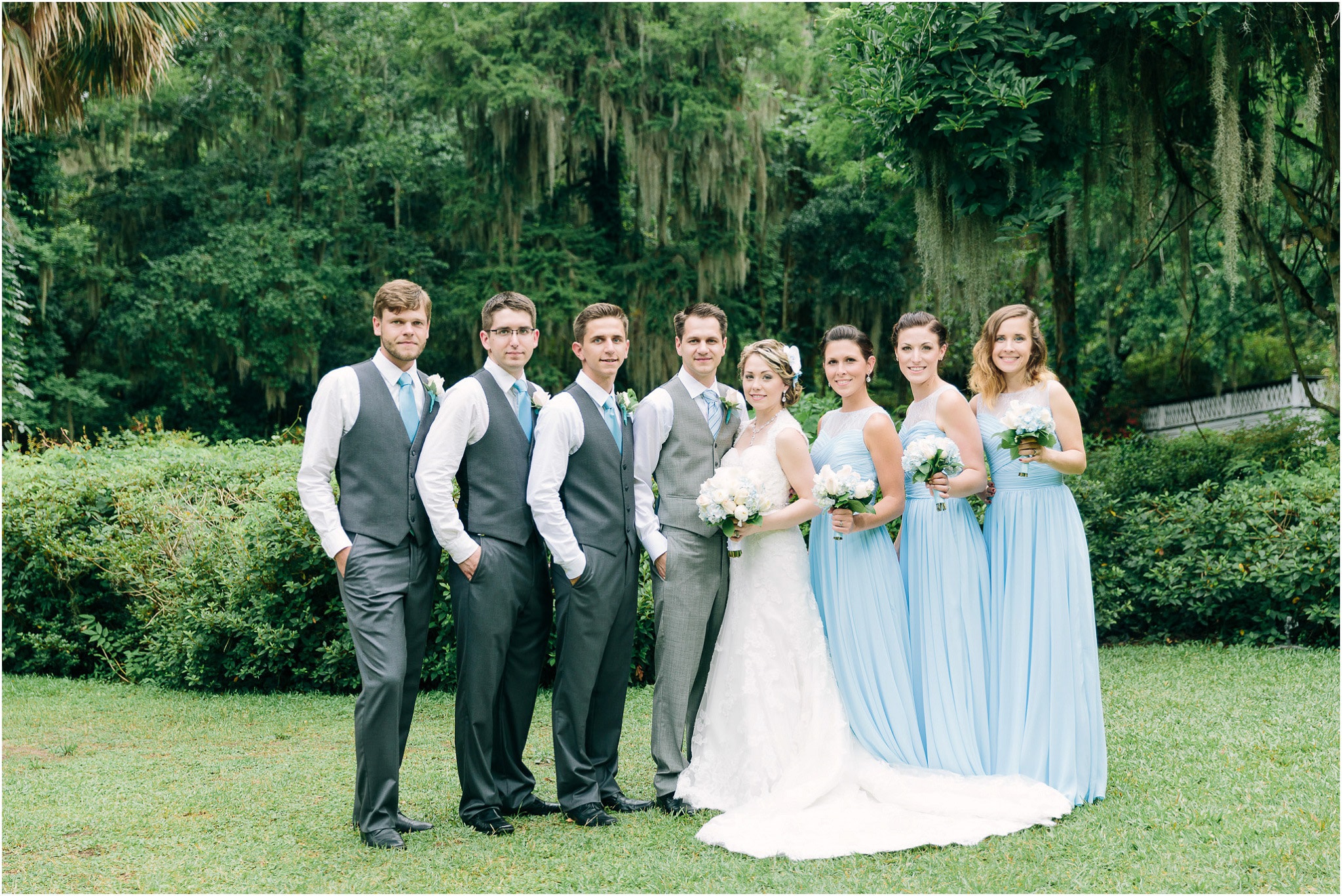 Bridal party for the Ashley and Daniil's wedding with a near jungle backdrop