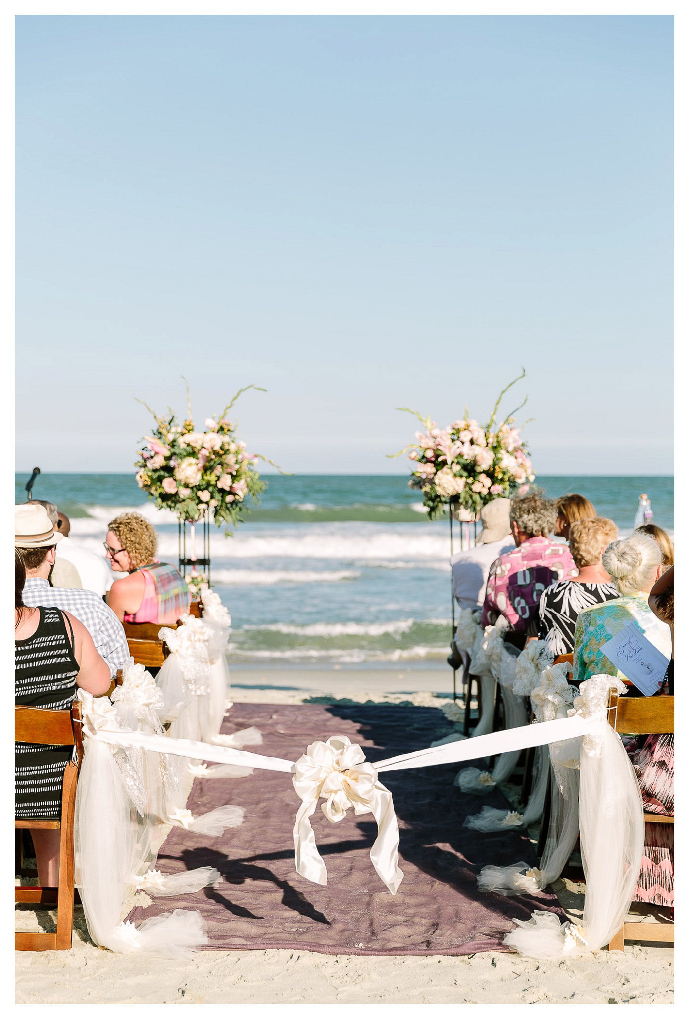Looking down the aisle and into the ocean - Beach wedding ceremony in Myrtle Beach, South Carolina - Venue - Beach House Gulf Stream Breeze, Beach Realty Catering and Cake - Buttercream Cakes and Catering, LLC Flowers - Callas Florist Event Rentals - Event Works DJ - Scott Shaw