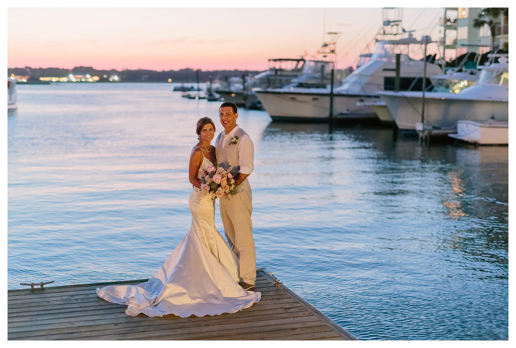 Bride and Groom on the edge of the dock at the marina - Venue - Beach House Gulf Stream Breeze, Beach Realty Catering and Cake - Buttercream Cakes and Catering, LLC Flowers - Callas Florist Event Rentals - Event Works DJ - Scott Shaw