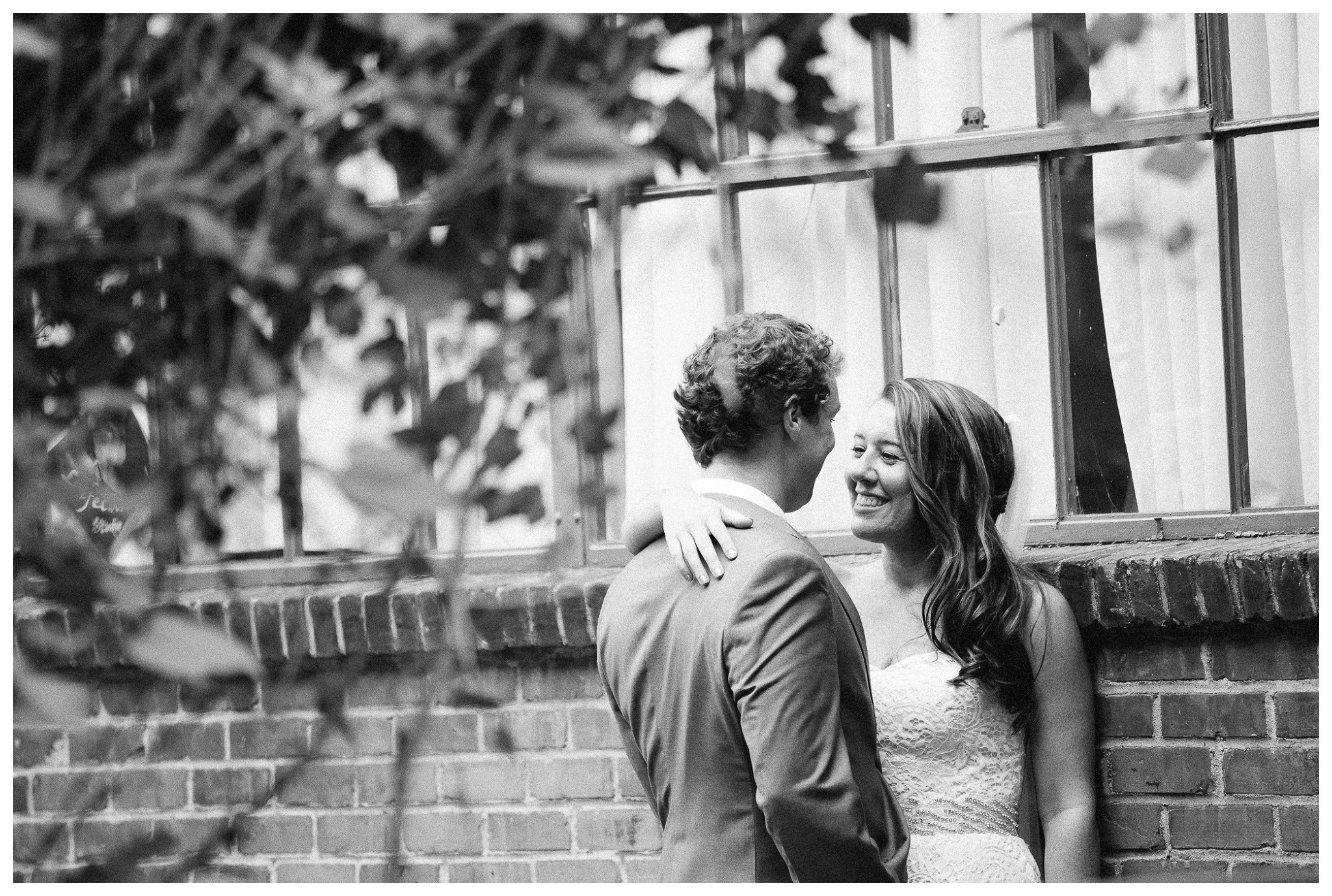 Love in Black and White, Bride and Groom black and white picture against a brick building, Venue and Catering – King plow Event Gallery and Bold American Events Decor and flowers – Stylish Stems Music and Band – Seven Sharp Nine Transportation – Georgia Trolley Photographer One Life Photography