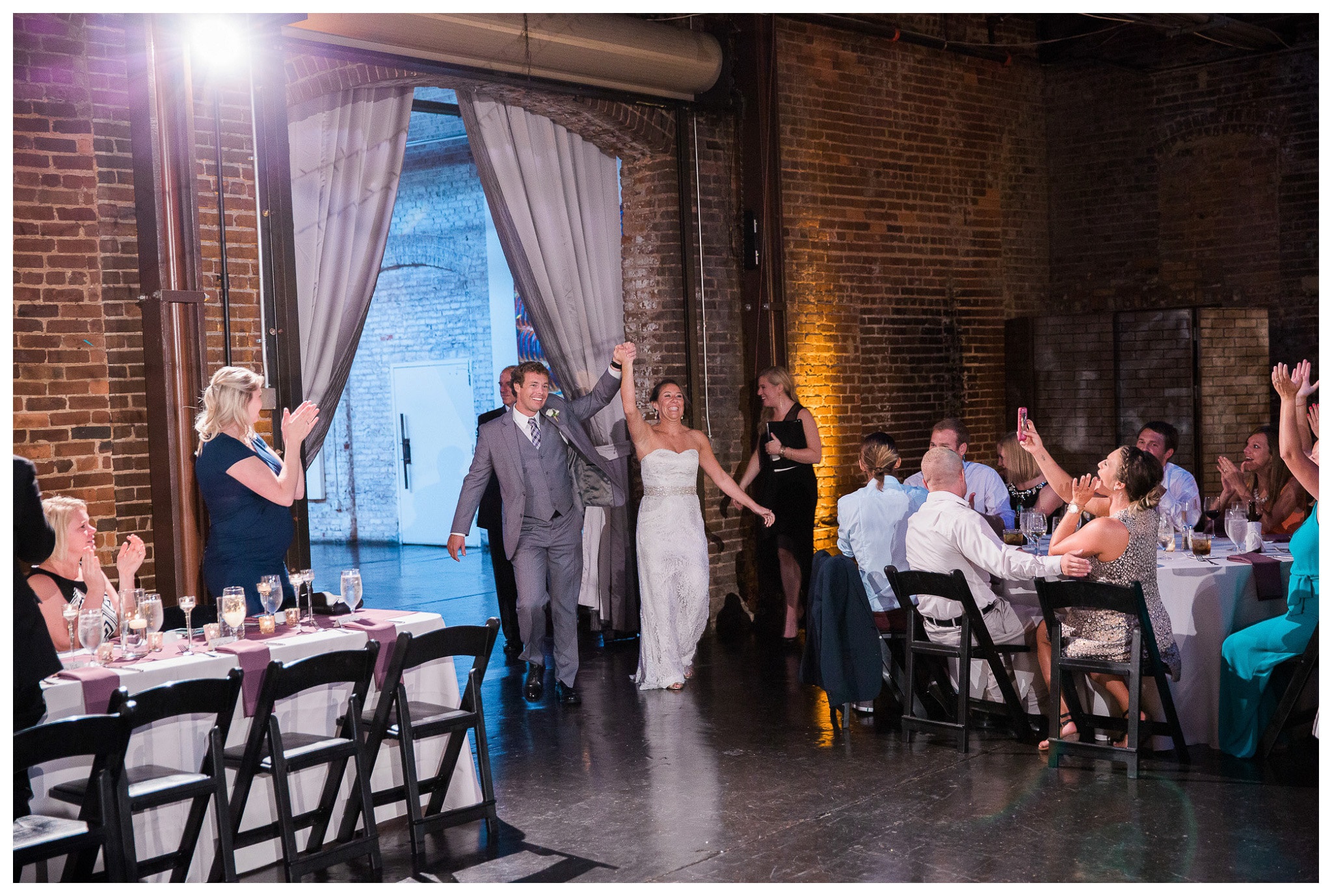 Groom and Bride arriving at the reception to the applause of their guests - Venue and Catering – King plow Event Gallery and Bold American Events Decor and flowers – Stylish Stems Music and Band – Seven Sharp Nine Transportation – Georgia Trolley Photographer One Life Photography