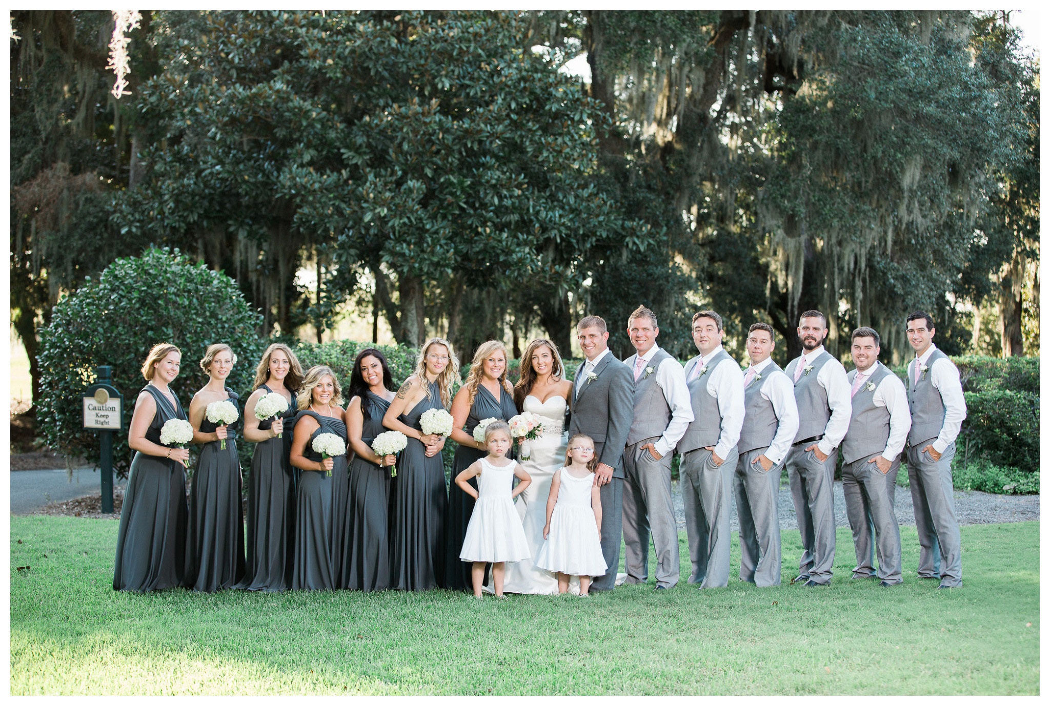 The Full Wedding Party - Kay and Josh's wedding at the Heritage Plantation, Pawleys Island, South Carolina on September 19, 2015 Heritage Plantation Southern wedding, Pawleys Island, South Carolina Venue and Catering: Heritage Club, Pawleys Island Music: Paul Matthews Entertainment Brides dress: The Little White Dress Cake: Buttercream Cakes and Catering Event Rentals: Eventworks Photographer: One Life Photography