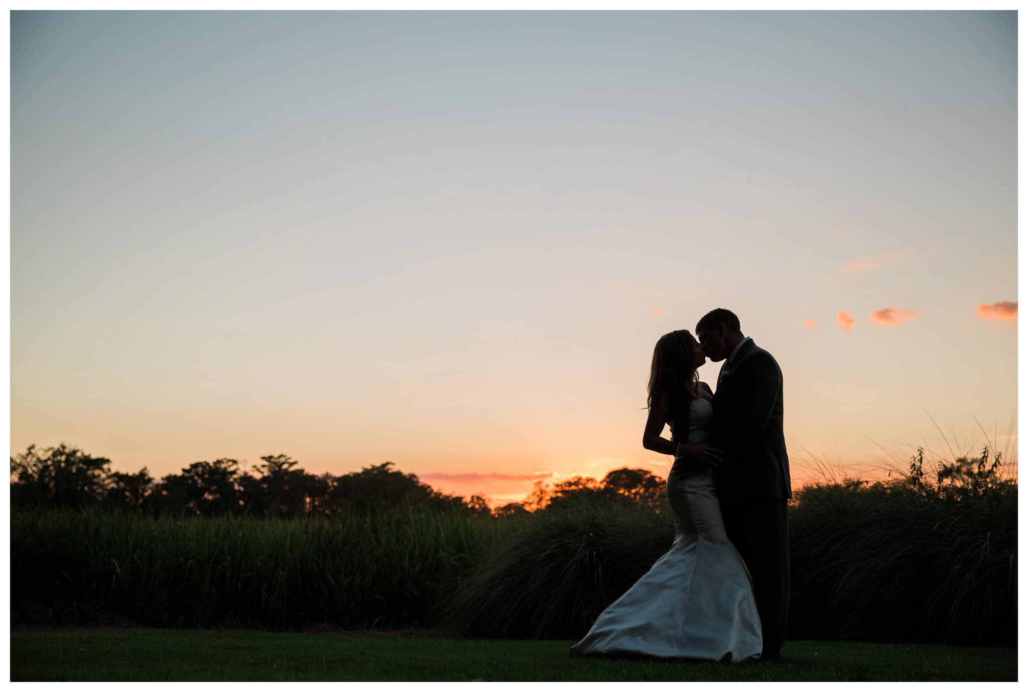 Kay and Josh's kiss during the setting of the sun,  wedding at the Heritage Plantation, Pawleys Island, South Carolina on September 19, 2015 Heritage Plantation Southern wedding, Pawleys Island, South Carolina Venue and Catering: Heritage Club, Pawleys Island Music: Paul Matthews Entertainment Brides dress: The Little White Dress Cake: Buttercream Cakes and Catering Event Rentals: Eventworks Photographer: One Life Photography