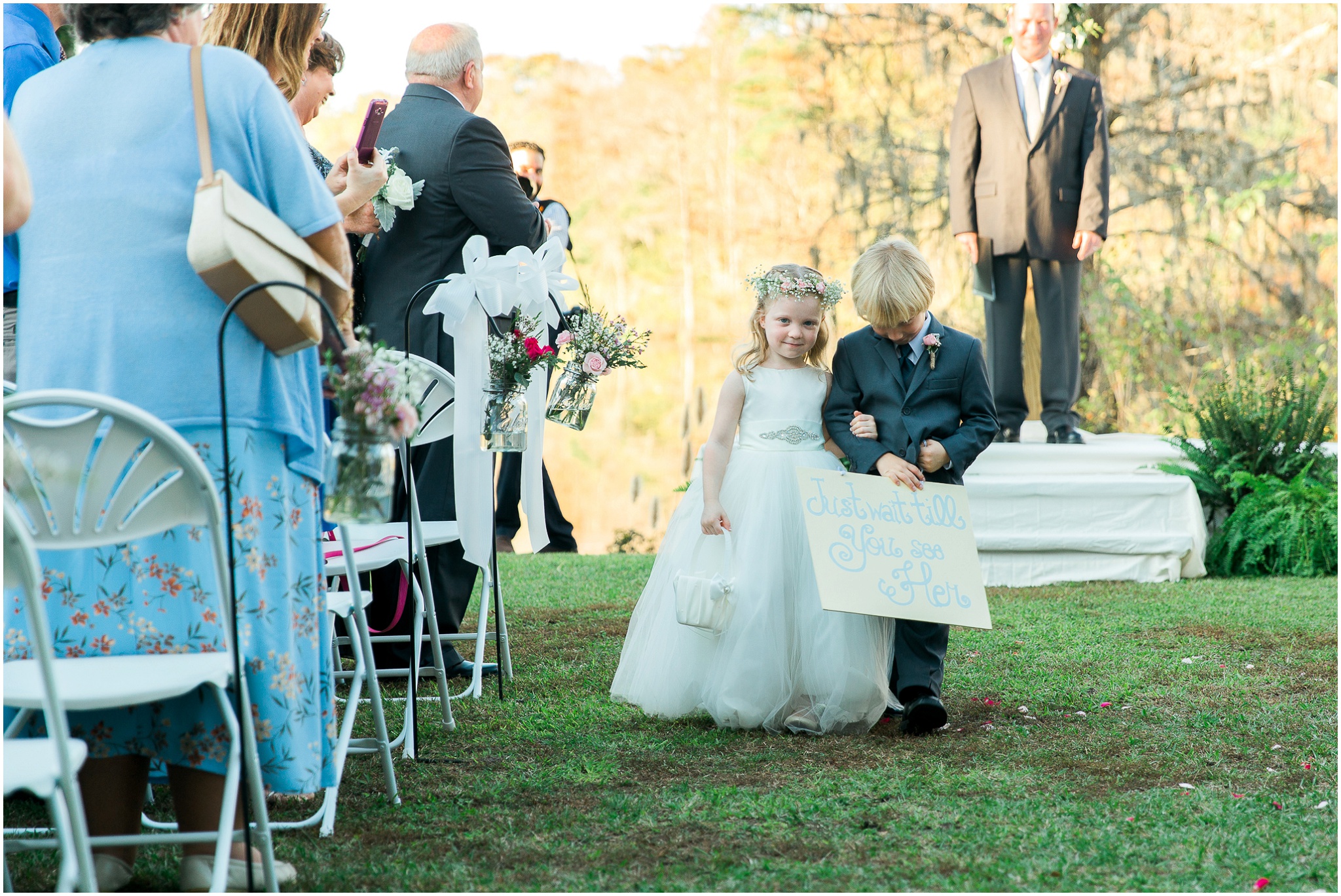 Ringbearer and Flower girl bashfully walking up the aisle, Paige and Dorsey, Upper Mill Plantation Wedding Session 20, Conway, South Carolina, Wedding coordinator, flowers and Cake - Willow Event Designs, Venue - Upper Mill Plantation, DJ - Carolina Entertainment, Dress - Foxy Lady, www.onelifephoto.net Photography