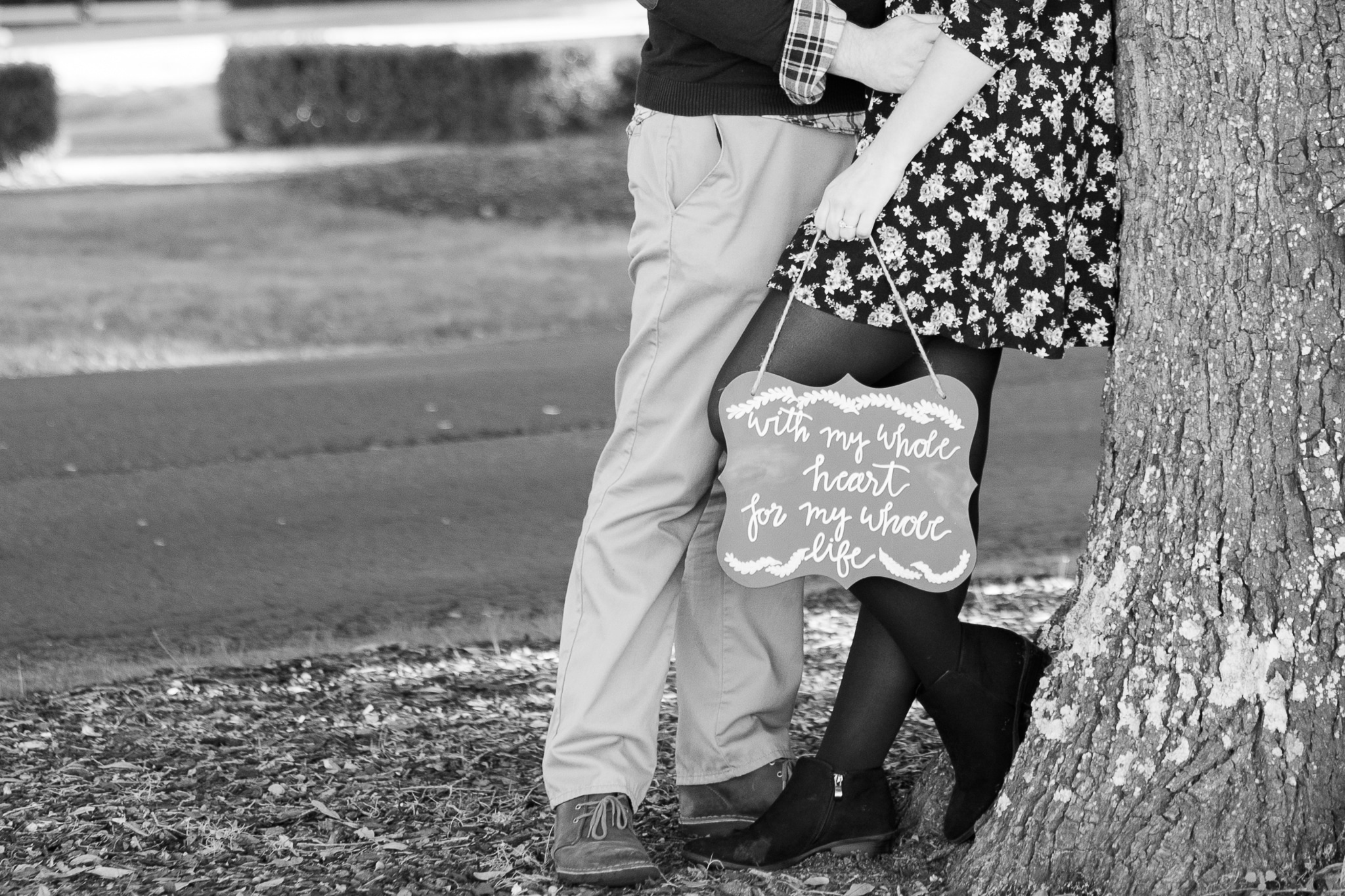 Brian and Kelsey, Black and white posed under a tree with a chalkboard sign Caledonia Golf and Fish Club, Myrtle Beach Engagement Photography Session 2
