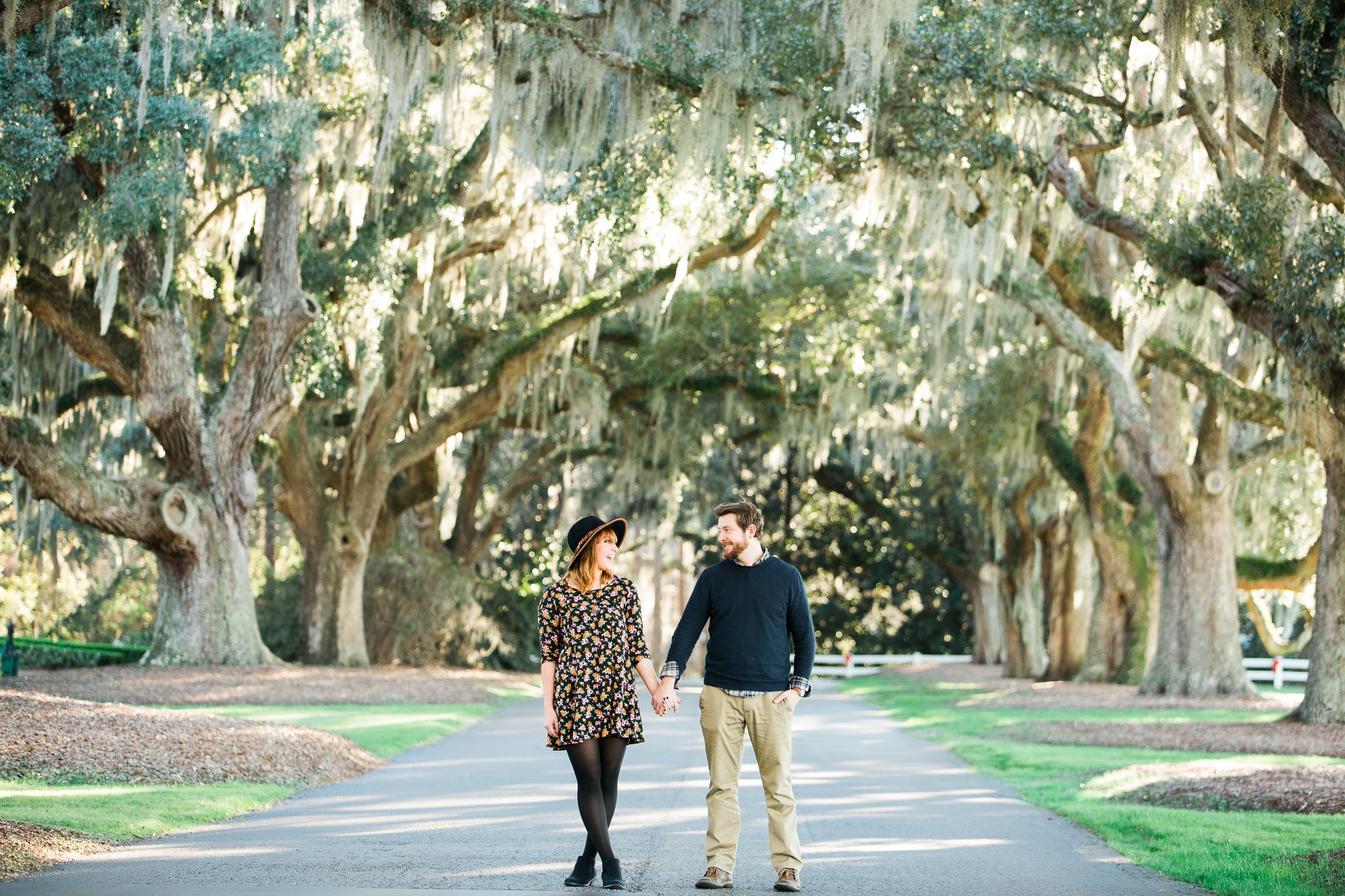 Brian and Kelsey walking along under a tree covered walkway, Caledonia Golf and Fish Club, Myrtle Beach Engagement Session 14, www.onelifephoto.net