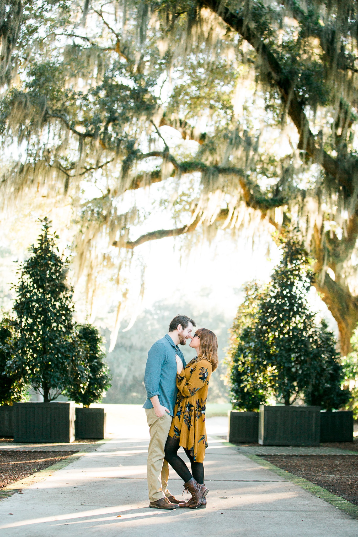 Brian and Kelsey preparing to kiss under a whispy tree, Caledonia Golf and Fish Club, Myrtle Beach Engagement Session 15, www.onelifephoto.net