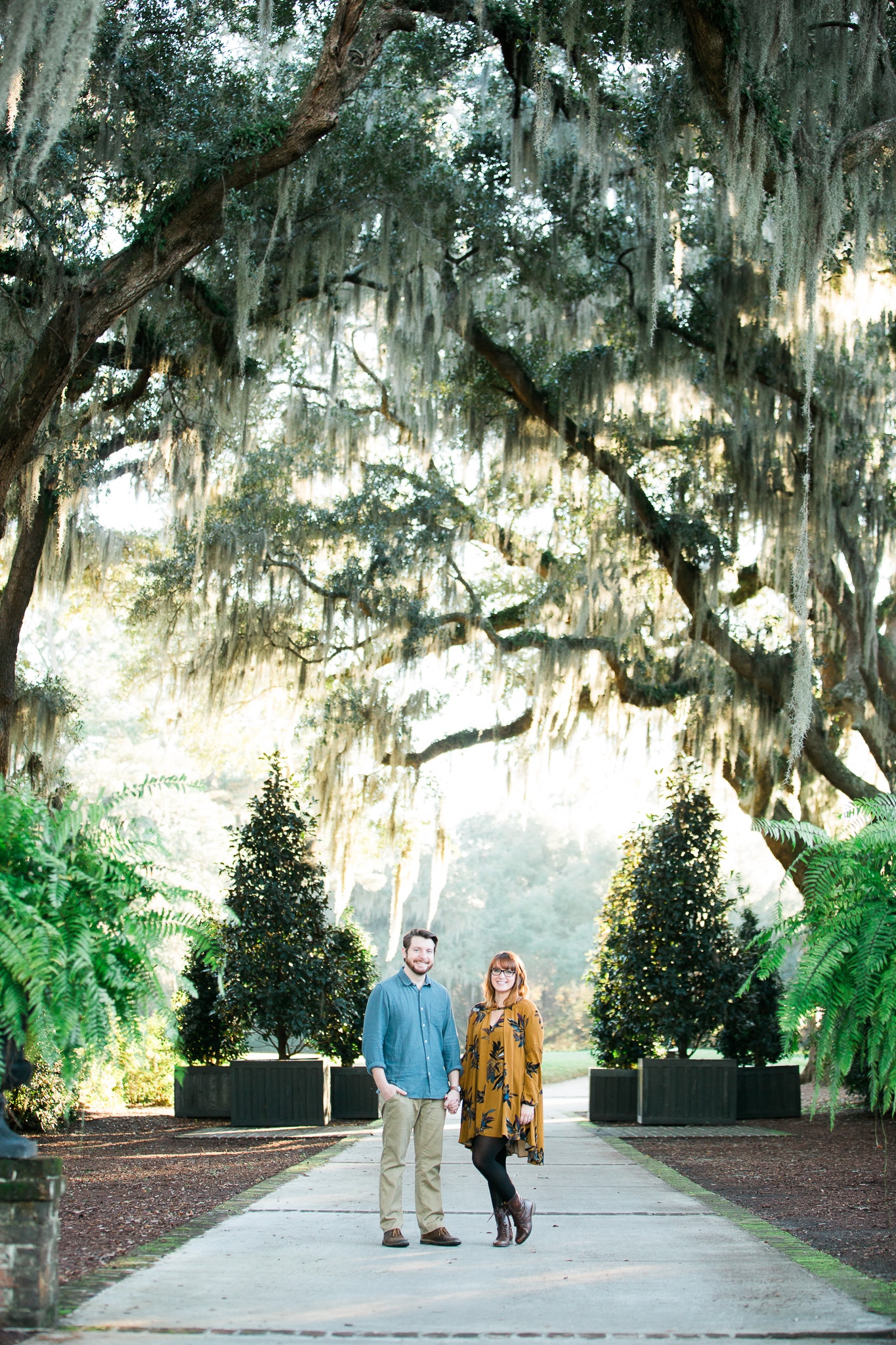 Brian and Kelsey smiling holding hands under the whispy trees, Caledonia Golf and Fish Club, Myrtle Beach Engagement Session 18, www.onelifephoto.net