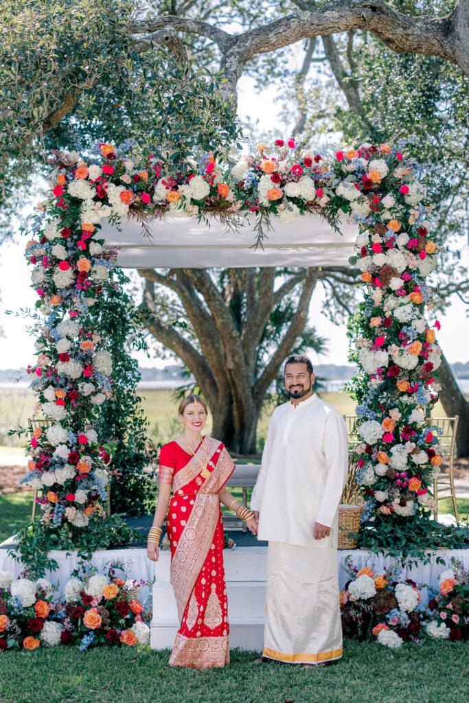 Couple in Front of floral ceremony arch