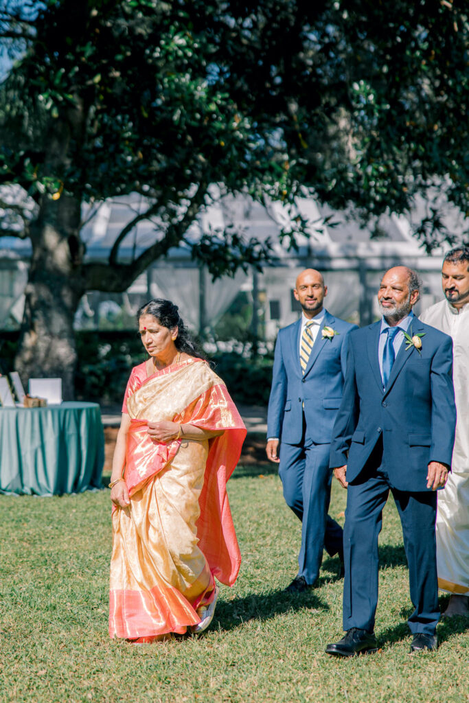 Groom walking with his parents