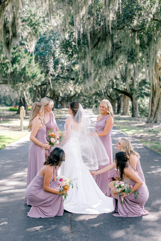 Bride and her bridesmaids in front of oak tress